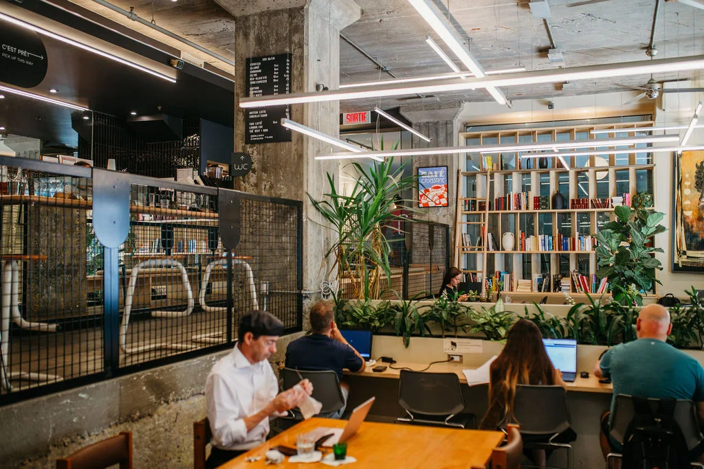 Paper Hill's café, book wall, and shared tables